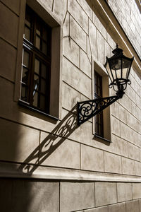 Low angle view of street light against building