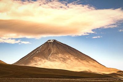 Scenic view of volcanic mountain against sky