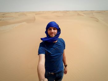 Portrait of young man in desert