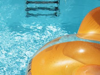 High angle view of yellow inflatable toy floating on swimming pool