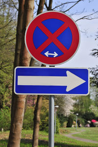 Close-up of road sign against trees