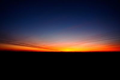 Scenic view of silhouette landscape against romantic sky at sunset