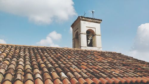 Roof and tower bell of a church against blue sky