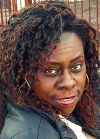 Close-up portrait of woman with curly hair