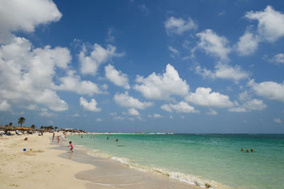 Scenic view of beach against cloudy sky