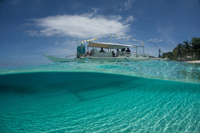 People in swimming pool against blue sky