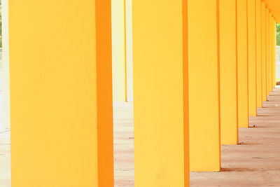 Yellow colonnade in empty corridor