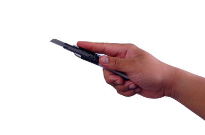 Close-up of person holding hands against white background