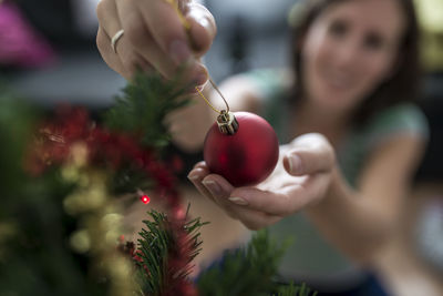 Midsection of woman holding red berries