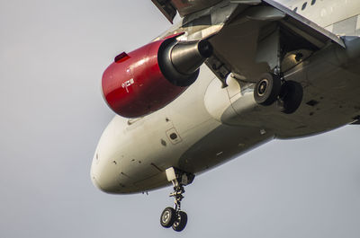 Close-up of airplane flying over white background