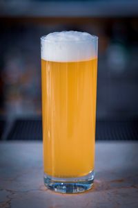 Close-up of beer glass on table