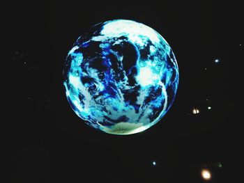 Close-up of blue moon against black background