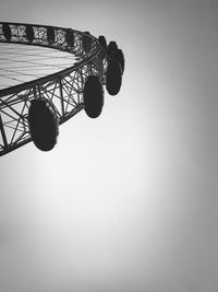 Low angle view of ferris wheel against clear sky