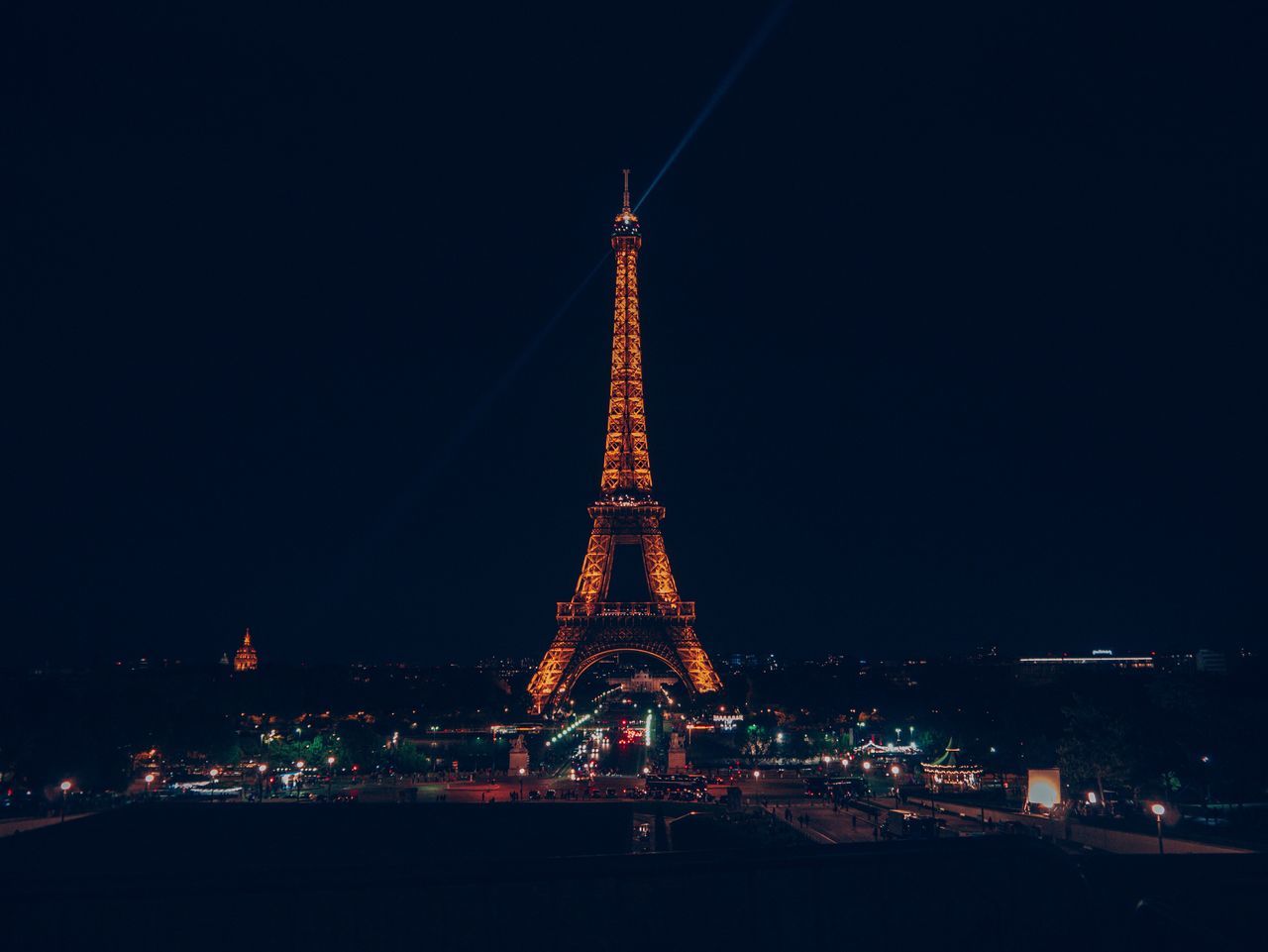 ILLUMINATED BUILDINGS IN CITY AGAINST SKY