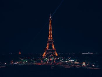 Illuminated buildings in city against sky at night