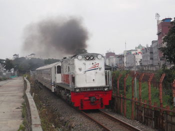 Train on railroad tracks against sky