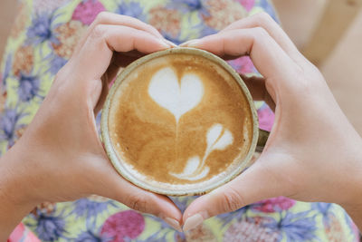 Midsection of woman holding coffee cup