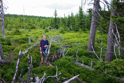 Man amidst plants and trees in forest