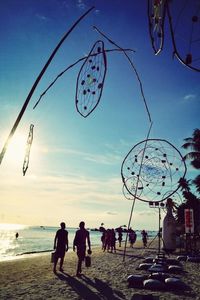 People enjoying against cloudy sky