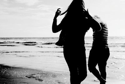 Silhouette of tourists on beach