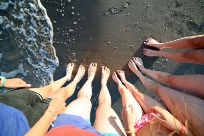 Low section of people with hands in water