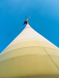 Low angle view of wind turbine against blue sky