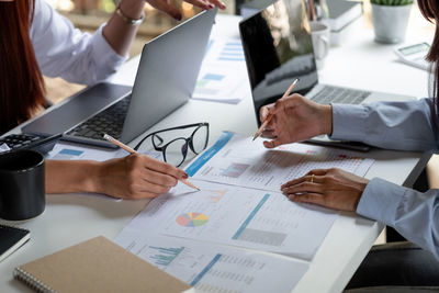 Midsection of man using smart phone