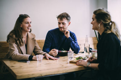 Young couple sitting on table at restaurant