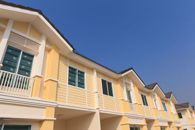 Low angle view of building against clear blue sky