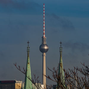 Low angle view of communications tower against sky