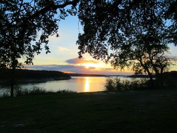 Scenic view of lake against sky during sunset