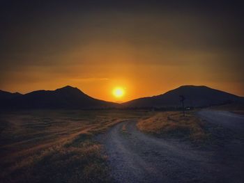 Scenic view of road against sky during sunset