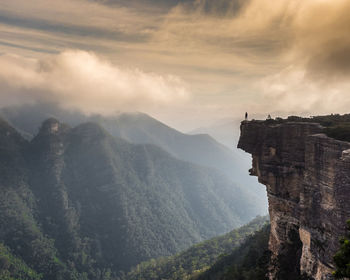 Scenic view of mountains against cloudy sky