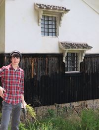 Full length of man standing outside house