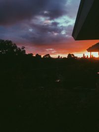 Silhouette trees against sky at sunset