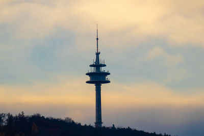 Silhouette of communications tower during sunset