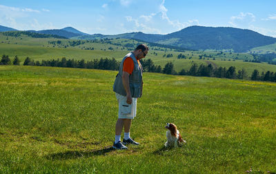 Man and dog in a wonderful mountain landscape in spring