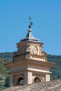 Low angle view of ornate building against clear blue sky