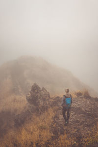 Woman hiker on the cobbled misty path on the mountain crest on santo antao island, cape verde