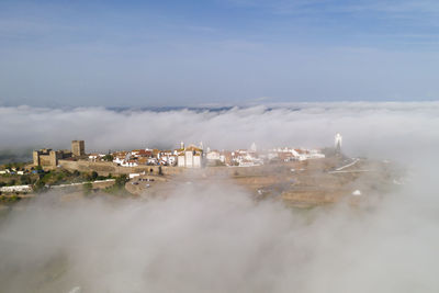 Monsaraz drone aerial view on the clouds in alentejo, portugal