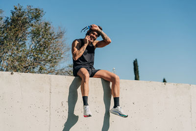 Low section of person against clear blue sky