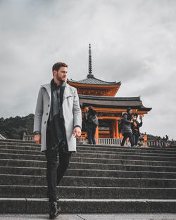 Low angle view of man walking at temple