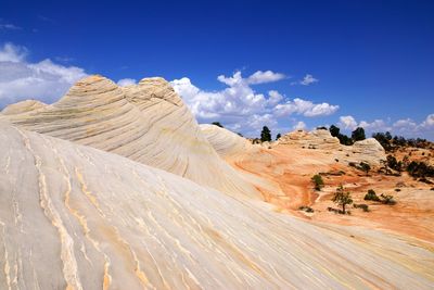 Scenic view of desert against cloudy sky