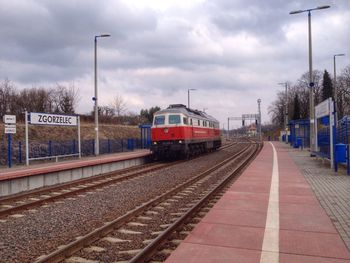 Railroad track against cloudy sky