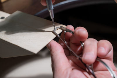 Cropped hand of man holding equipment