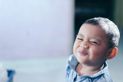 Close-up of baby girl making face at home