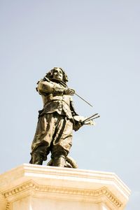 Low angle view of angel statue against clear sky