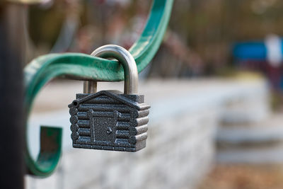 Close-up of padlock hanging on metal