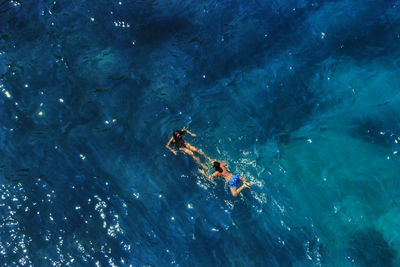 High angle view of people swimming in sea