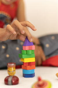 Midsection of woman with toy toys on table at home